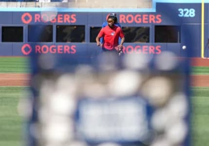Toronto Blue Jays first baseman Vladimir Guerrero Jr. (27) fields balls during batting practice before a game against the New York Yankees at Rogers Centre.