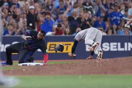 Toronto Blue Jays first baseman Vladimir Guerrero Jr. runs into New York Yankees shortstop George Lombard Jr. (96) during the sixth inning at Rogers Centre.