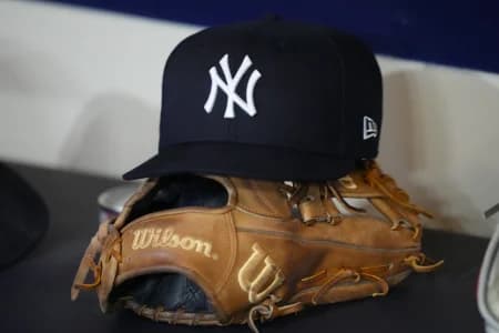 General view of a New York Yankees hat and glove prior to the game against the Milwaukee Brewers at American Family Field.