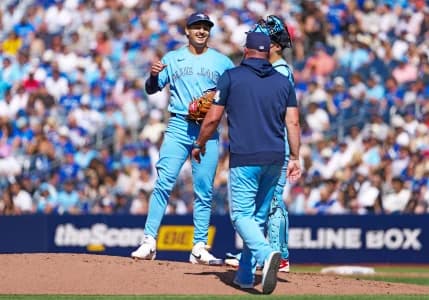 Toronto Blue Jays relief pitcher Ricky Tiedemann (33) is relieved by manager John Schneider (14) against the New York Yankees during the third inning at Rogers Centre.