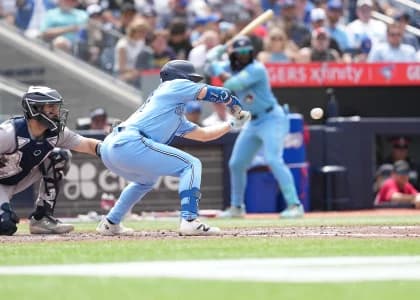 Toronto Blue Jays right fielder Brett Bateman (21) bunts the ball for a single against the New York Yankees during the sixth inning at Rogers Centre.