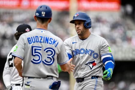 Toronto Blue Jays designated hitter George Springer (4) reacts after hitting a single against the New York Yankees during the fifth inning at Yankee Stadium.