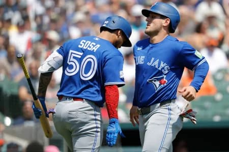 Toronto Blue Jays center fielder Daulton Varsho (5) receives congratulations from Toronto Blue Jays second baseman Lenyn Sosa (50) after scoring in the first inning against the Detroit Tigers at Comerica Park.