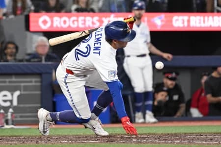 Toronto Blue Jays second baseman Ernie Clement (22) falls over after fouling a pitch off his knee against the Kansas City Royals in the eighth inning at Rogers Centre.