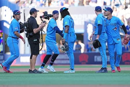 Toronto Blue Jays first baseman Charles McAdoo (26) celebrates the win with pinch hitter  second baseman Ernie Clement (22) against the New York Yankees at the end of the ninth inning at Rogers Centre.