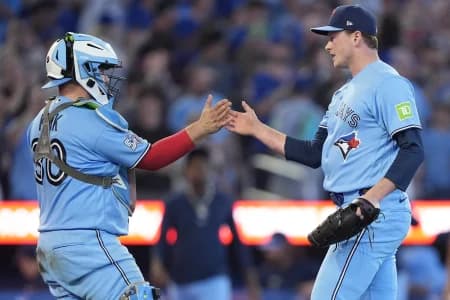 Toronto Blue Jays catcher Alejandro Kirk (30) and pitcher Louie Varland (77) celebrate a win over the Kansas City Royals at Rogers Centre.