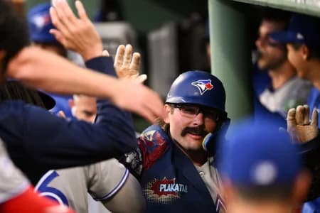 Toronto Blue Jays left fielder Davis Schneider (36) celebrates with his teammates after hitting a solo home run against the Boston Red Sox during the fifth inning at Fenway Park.