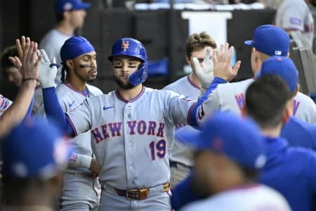 New York Mets third base Bo Bichette (19) celebrates with teammates in the dugout after hitting a home run during the third inning against the Chicago White Sox at Rate Field.