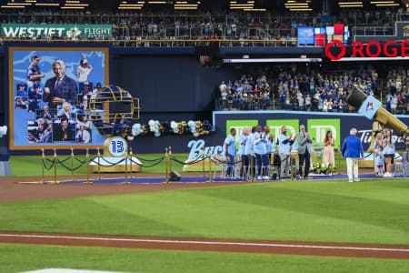 Buck Martinez walks to the podium during a pregame celebration before a game between the Toronto Blue Jays and Seattle Mariners at Rogers Centre