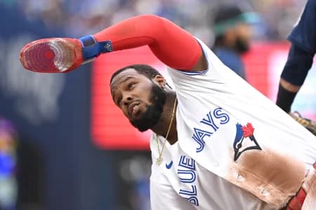 Toronto Blue Jays first baseman Vladimir Guerrero Jr. (27) ask for time after sliding safely into third base against the Seattle Mariners in the fifth inning at Rogers Centre.