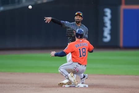 New York Mets second baseman Marcus Semien (10) attempts to turn a double play with Houston Astros center fielder Daulton Varsho (18) sliding into second base during the seventh inning at Citi Field.