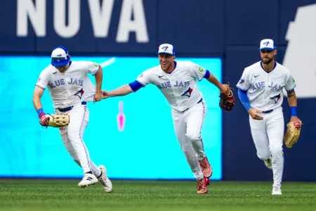 Toronto Blue Jays center fielder Myles Straw (3) celebrates with center fielder Brett Bateman (21) and right fielder Nathan Lukes (38) after defeating the Seattle Mariners at Rogers Centre