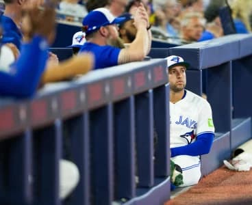 Toronto Blue Jays designated hitter George Springer (4) sits outside the dugout during a pregame celebration before playing the Seattle Mariners at Rogers Centre