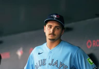 Toronto Blue Jays relief pitcher Ricky Tiedemann (33) stands in the dugout against the New York Yankees during the third inning at Rogers Centre.