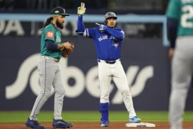 Toronto Blue Jays right fielder Anthony Santander (25) celebrates at second base in the second inning against the Seattle Mariners during game one of the ALCS round for the 2025 MLB playoffs at Rogers Centre
