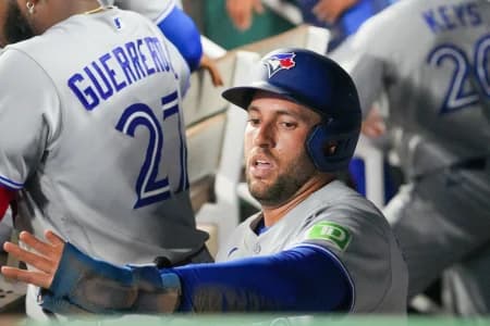 Toronto Blue Jays designated hitter George Springer (4) celebrates in the dugout after scoring against the Kansas City Royals during the seventh inning at Kauffman Stadium.