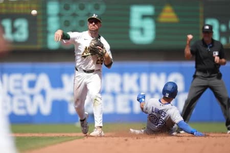Athletics second baseman Donovan Walton (29) turns a double play in front of Toronto Blue Jays outfielder Nathan Lukes (38) in the fifth inning at Sutter Health Park.