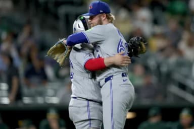 Toronto Blue Jays pitcher Spencer Miles (62) hugs catcher Alejandro Kirk (30) after their win against the Athletics at Sutter Health Park.