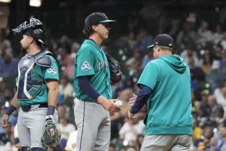 Seattle Mariners pitcher Logan Gilbert (36) is taken out of the game by Seattle Mariners manager Dan Wilson (6) in the sixth inning against the Milwaukee Brewers at American Family Field.