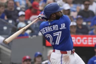 Toronto Blue Jays first baseman Vladimir Guerrero Jr. (27) hits a single against the Baltimore Orioles during the eighth inning at Rogers Centre.