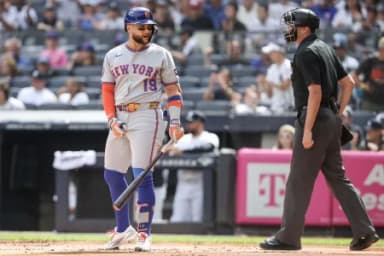 New York Mets third baseman Bo Bichette (19) argues with home plate umpire Willie Traynor (45) after being called out on strikes in the first inning against the New York Yankees at Yankee Stadium