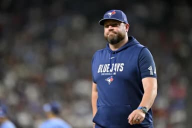 Toronto Blue Jays manager John Schneider walks back to the dugout during the sixth inning against the Texas Rangers at Globe Life Field.
