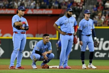 Toronto Blue Jays third baseman Kazuma Okamoto (7) and shortstop Andres Gimenez (0) and first baseman Vladimir Guerrero Jr. (27) and third baseman Ernie Clement (22) look on during the sixth inning against the Texas Rangers at Globe Life Field.