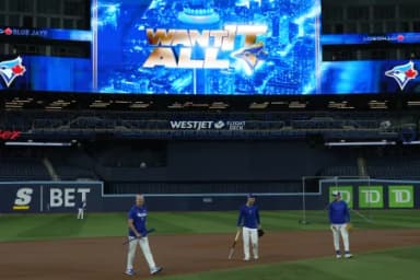 Toronto Blue Jays second baseman Andres Gimenez (center) and Toronto Blue Jays starting pitcher Shane Bieber (right) warm up during batting pratice on media day before game one of the World Series at Rogers Centre
