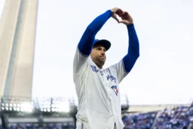 Toronto Blue Jays designated hitter George Springer (4) makes a heart shape with his hands to salute the fans after defeating the Cincinnati Reds at Rogers Centre.
