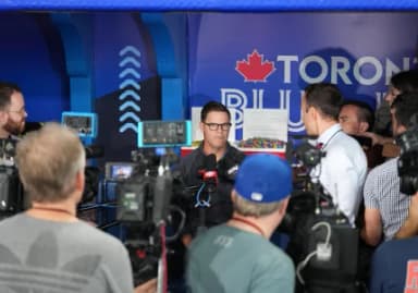 Toronto Blue Jays general manager Ross Atkins talks to the media during batting practice before a game against the Minnesota Twins at Rogers Centre.