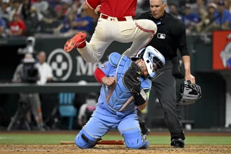 Texas Rangers left fielder Wyatt Langford (36) collides with Toronto Blue Jays catcher Alejandro Kirk (30) and scores a run during the sixth inning at Globe Life Field