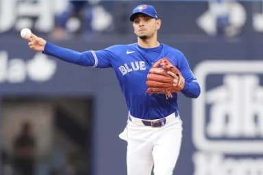 Toronto Blue Jays shortstop Andres Gimenez (0) throws out Cincinnati Reds first baseman Sal Stewart (not pictured) at first base during the ninth inning at Rogers Centre