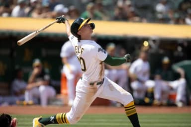 Oakland Athletics second baseman Zach Gelof (20) follows the flight of his RBI double against the Minnesota Twins during the seventh inning at Oakland-Alameda County Coliseum