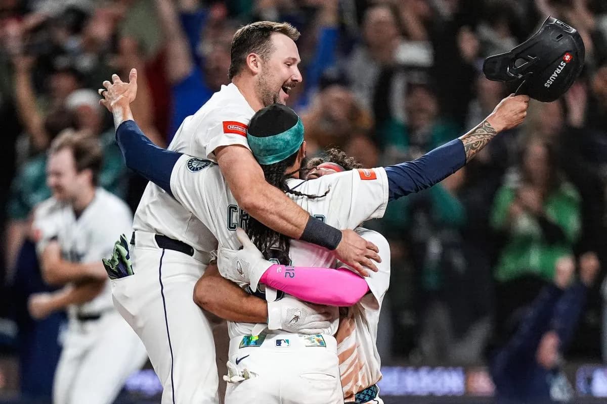 From left, Seattle Mariners catcher Cal Raleigh (29), shortstop J.P. Crawford (3) and first baseman Josh Naylor (12) celebrate 3-2 win over Detroit Tigers after 15 innings at ALDS Game 5 at T-Mobile Park in Seattle on Friday, Oct. 10, 2025