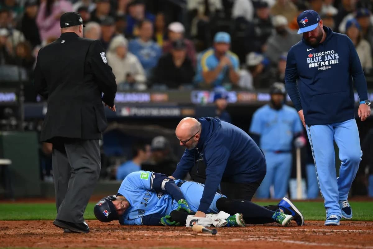 Toronto Blue Jays designated hitter George Springer (4) is helped by training staff after getting hit by a pitch against the Seattle Mariners during the seventh inning during game five of the ALCS round for the 2025 MLB playoffs at T-Mobile Park.