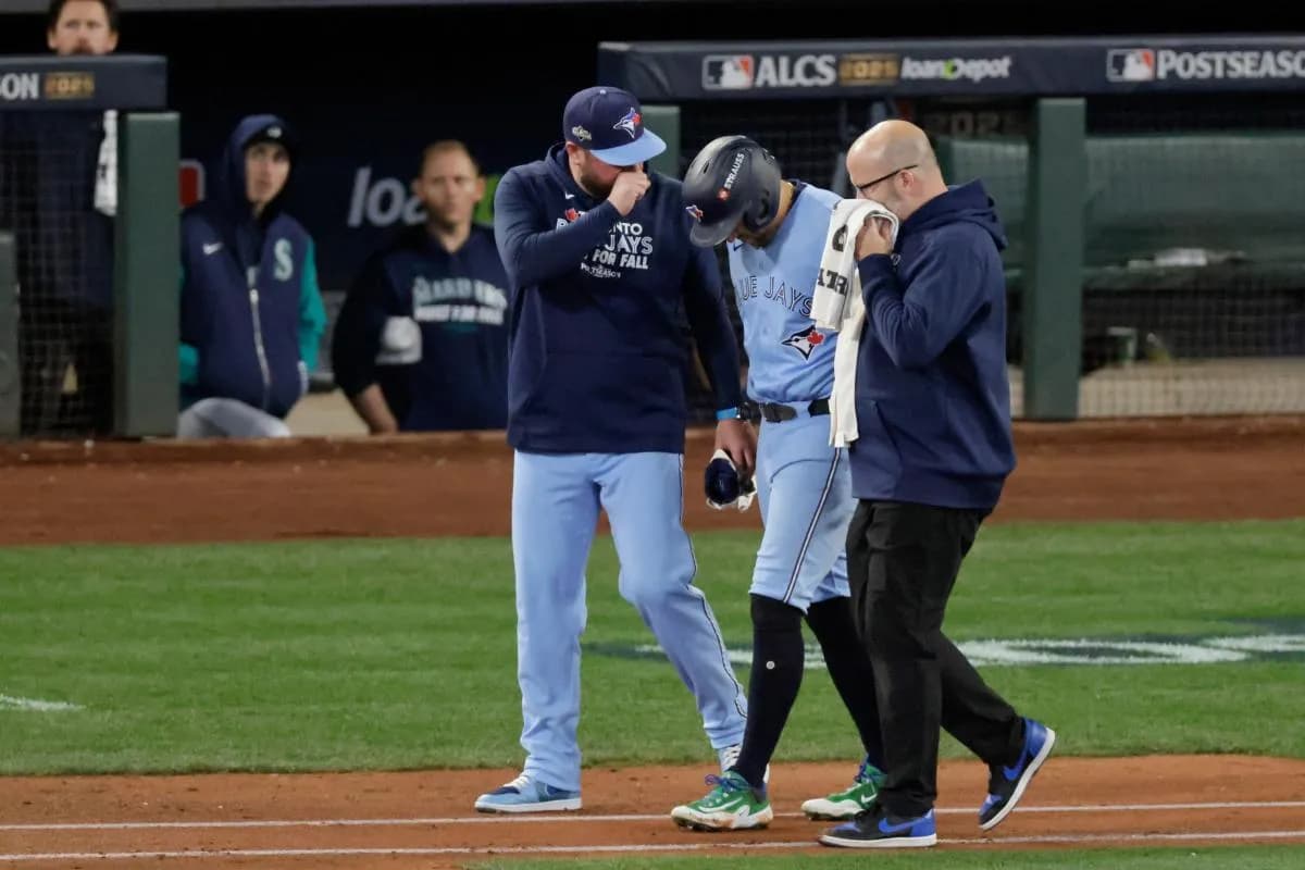 Toronto Blue Jays manager John Schneider (14) checks on designated hitter George Springer (4) after being hit by a pitch in the seventh inning during game five of the ALCS round for the 2025 MLB playoffs at T-Mobile Park.