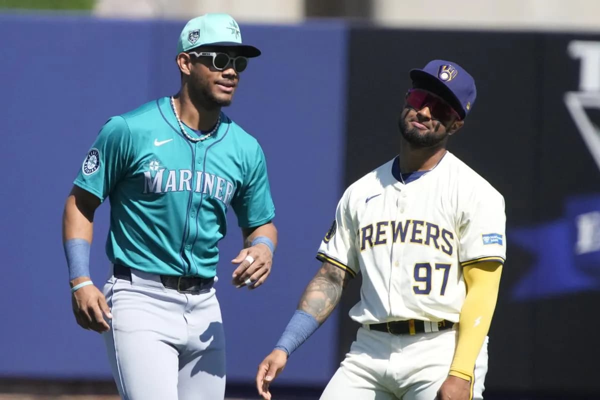 Seattle Mariners center fielder Julio Rodriguez (44) and Milwaukee Brewers right fielder Hedbert Perez (97) joke around before a game at American Family Fields of Phoenix.