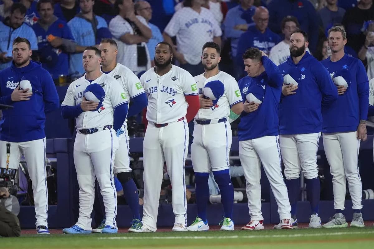 Toronto Blue Jays players line up during the national anthems before game seven of the 2025 MLB World Series against the Los Angeles Dodgers at Rogers Centre.
