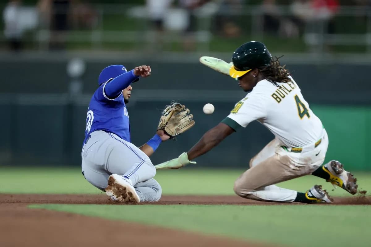 Athletics right fielder Lawrence Butler (4) is tagged out by Toronto Blue Jays second baseman Leo Jimenez (49) on a steal attempt during the fifth inning at Sutter Health Park.