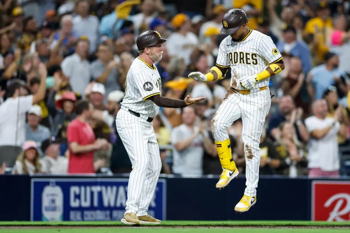 San Diego Padres designated hitter Luis Arraez (4) celebrates with Coach Tim Leiper (33) after hitting a two-run home run during the second inning against the Milwaukee Brewers at Petco Park.
