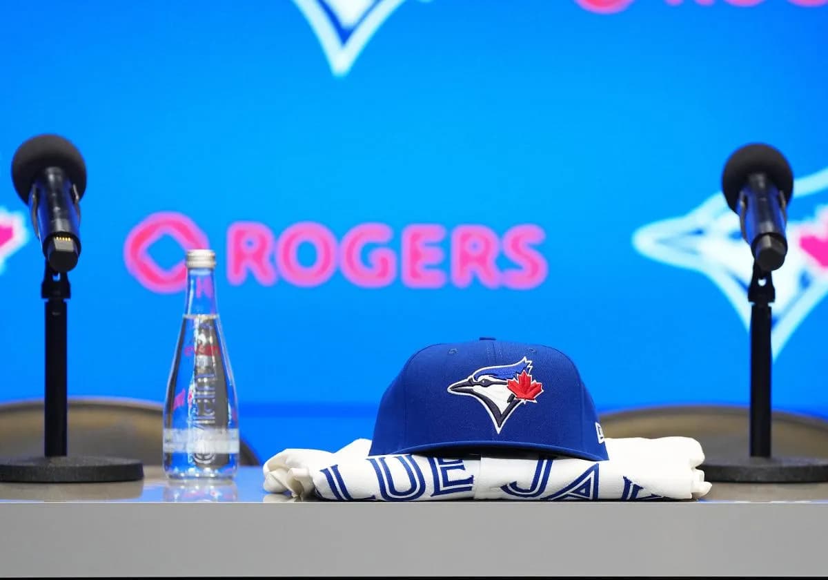 A Toronto Blue Jays cap and jersey sit on the table before the Toronto Blue Jays press conference at Rogers Centre.