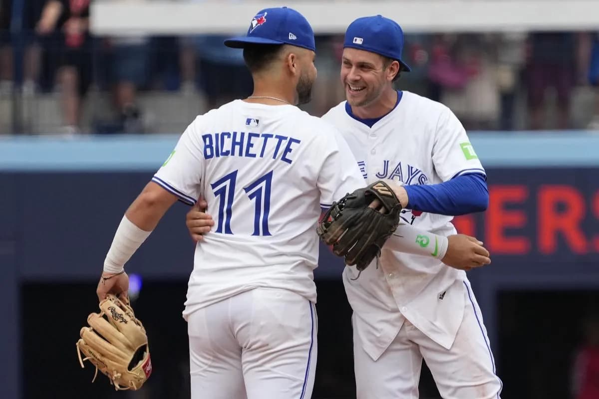 Toronto Blue Jays second baseman Ernie Clement (22) and shortstop Bo Bichette (11) celebrate a win over the San Francisco Giants at Rogers Centre.