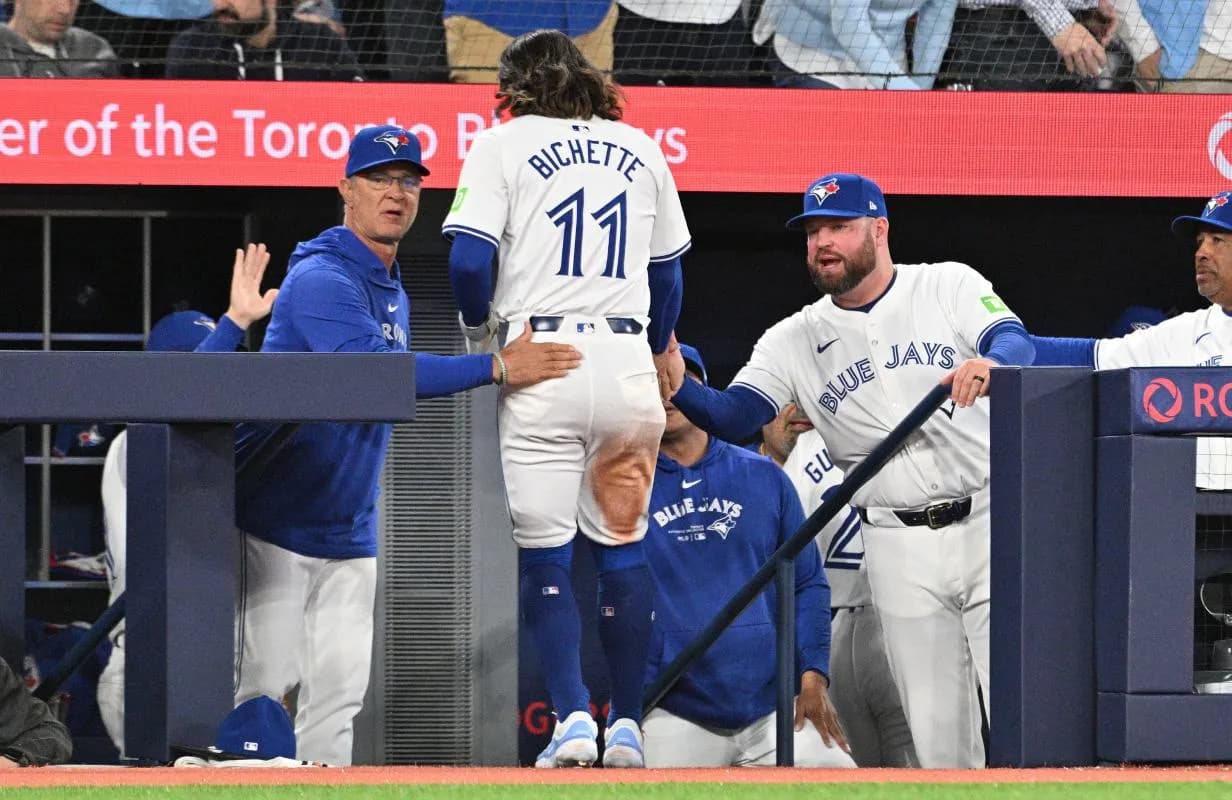 Toronto Blue Jays manager John Schneider (14) and bench coach Don Mattingly (23, left) greet shortstop Bo Bichette (11) after he scored against the Seattle Mariners in the fourth inning at Rogers Centre.