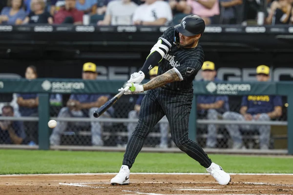 Chicago White Sox third baseman Yoan Moncada (10) hits a RBI-single against the Milwaukee Brewers during the first inning at Guaranteed Rate Field.