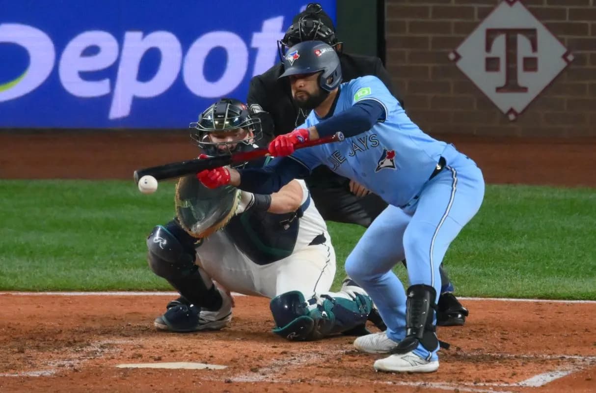Toronto Blue Jays shortstop Isiah Kiner-Falefa (7) sacrifice bunts in the eighth inning against the Seattle Mariners during game four of the ALCS round for the 2025 MLB playoffs at T-Mobile Park.