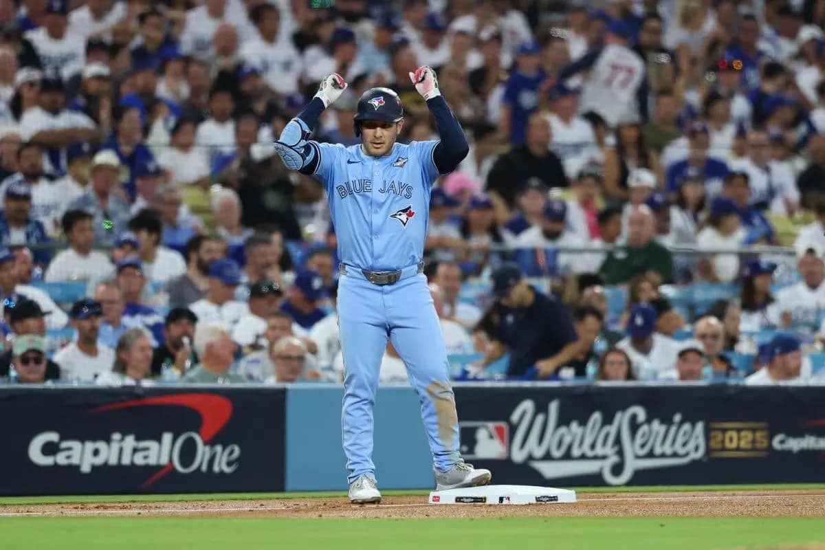 Toronto Blue Jays center fielder Daulton Varsho (5) celebrates after hitting a triple during the fourth inning against the Los Angeles Dodgers during game five of the 2025 MLB World Series at Dodger Stadium.