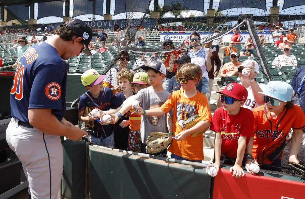 Fans wait for an autograph from Houston Astros catcher C.J. Stubbs (80) before the game against the St. Louis Cardinals at Roger Dean Stadium.