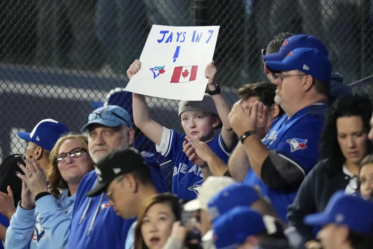 A fan holds up a sign to support the Toronto Blue Jays before game seven of the 2025 MLB World Series against the Los Angeles Dodgers at Rogers Centre.