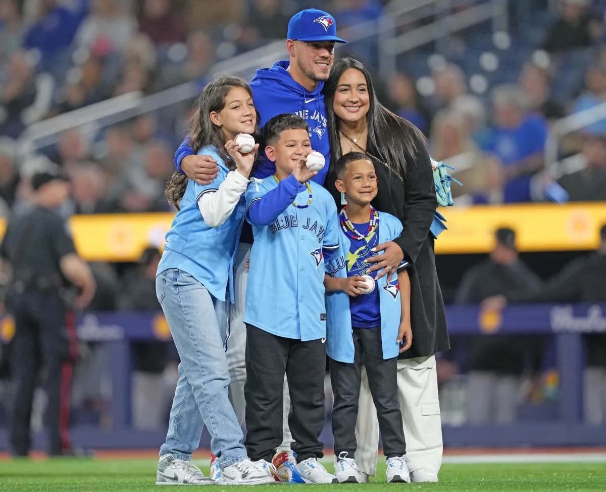 Toronto Blue Jays starting pitcher Jose Berrios (17) poses for a photo with his family after the first pitch before a game against the Colorado Rockies at Rogers Centre.