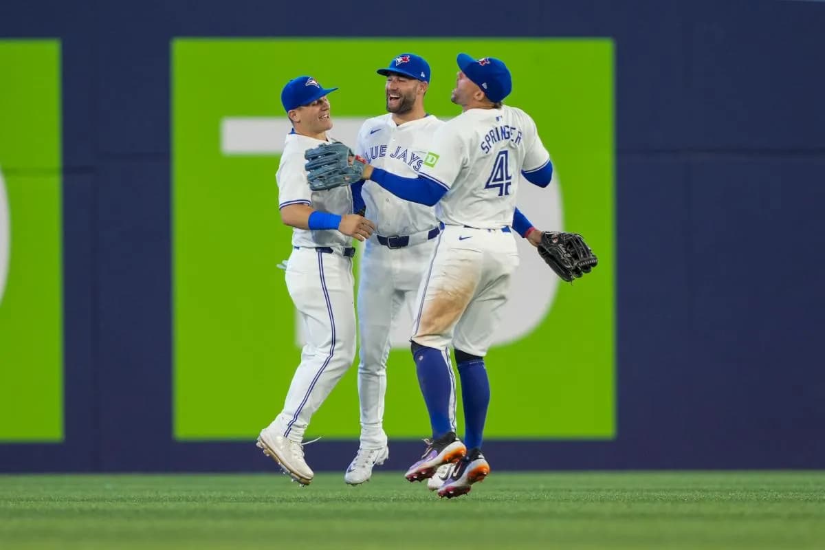 Toronto Blue Jays outfielder Kevin Kiermaier (39) celebrates with outfielder George Springer (4) and outfielder Daulton Varsho (25) after defeating the New York Yankees at Rogers Centre.